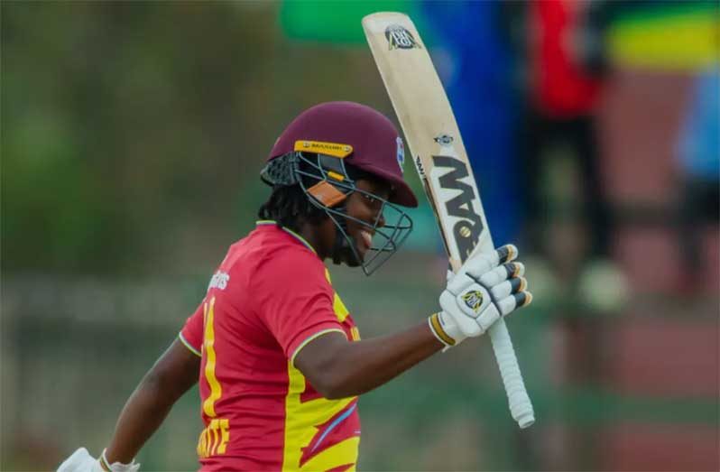 Eboni Brathwaite celebrates after reaching her half century against Zimbabwe Women