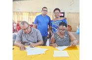 President of the Rotary Club of Georgetown Central Peter Pompey and Yolanda James, President, Eddie's Home signing the MoU