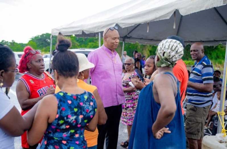 Minister of Public Works, Bishop Juan Edghill, engages residents of Sophia