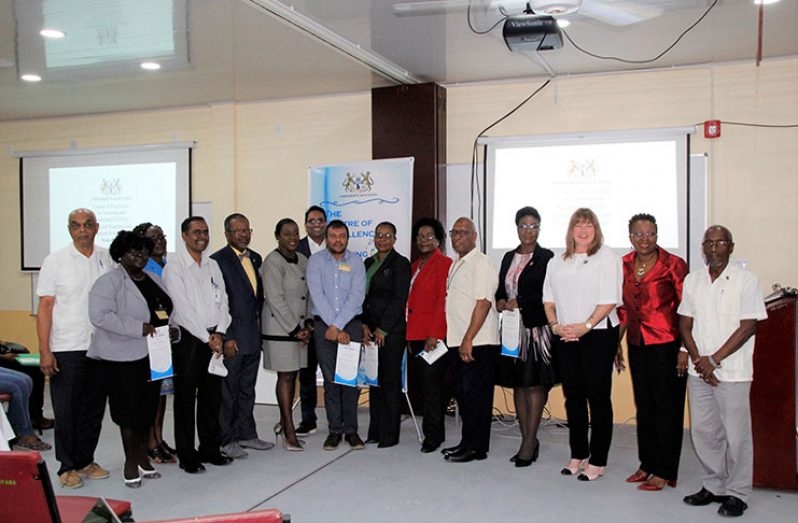 Vice-Chancellor, Professor Ivelaw Griffith and Minister of Education, Dr. Nicolette Henry pose with the newly installed members of the Advisory Board along with senior members of UG’s administration and the Florida International University (Ministry of Education photo)