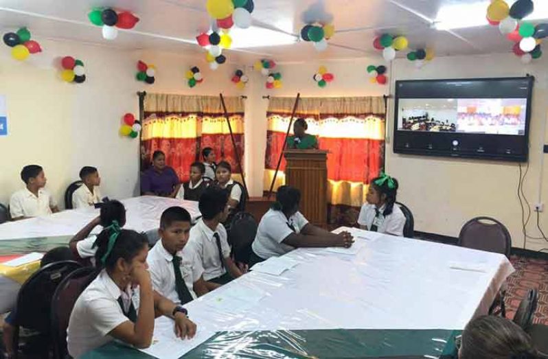 Minister of Education, Dr. Nicolette Henry, addressing  students of the Arapaima Primary and St. Ignatius Secondary schools at the launch of the Smart Classroom (DPI photo)