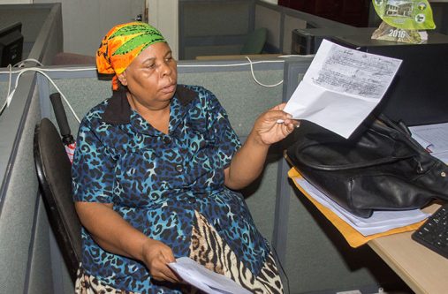 A distressed Lucillia Emanuel holding up a photocopied receipt which indicates that her husband had acquired the claim in 1987 from the GGMC