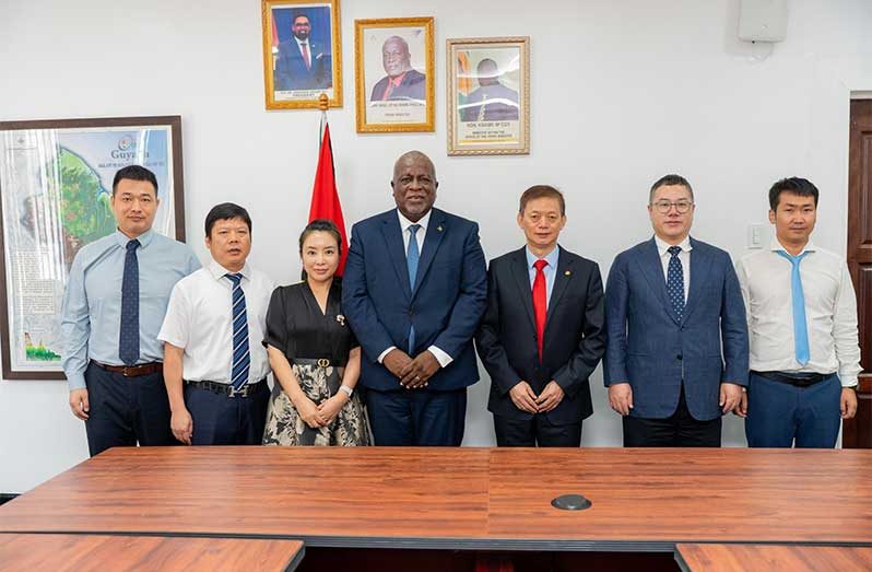 Prime Minister (PM), Brigadier (Ret’d) Mark Phillips flanked by the delegation, led by Mr. Guolai Zhang, President of POWERCHINA Americas