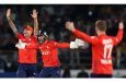 England players celebrate the fall of a wicket