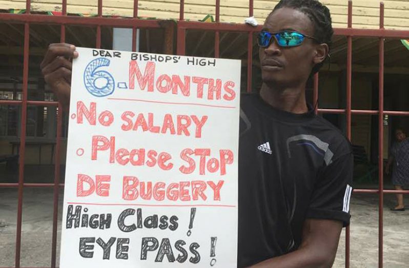 Physical Education teacher Tyson English protesting outside Bishops’ High on Friday