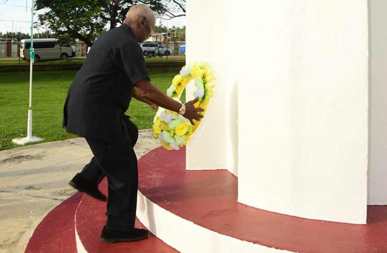 Minister Scott lays a wreath at the foot of the Enmore Martyrs Monument (Adrian Narine photo)