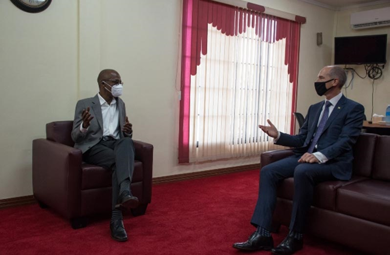 Labour Minister, Joseph Hamilton, in discussion with a representative of ExxonMobil on Wednesday (DPI photo) inister of Labour, Hon. Joseph Hamilton in discussion with a representative of ExxonMobil
