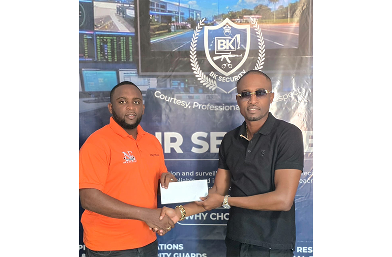 New Era Entertainment Co-Director, Andrew Major (left), receives the sponsorship from BK Security Managing Director, Travis Shepherd