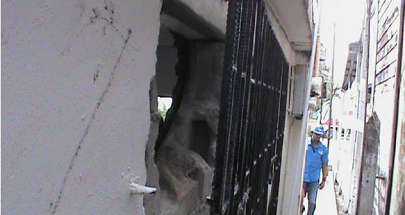 The ripped out steel grill and the hole in the concrete wall of the store at Anna Regina