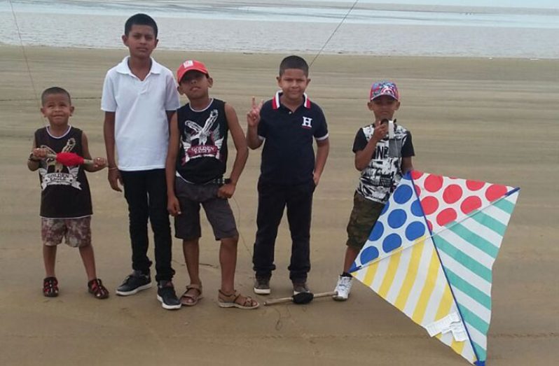 A group of young men having a rollicking time on the Golden Fleece Beach