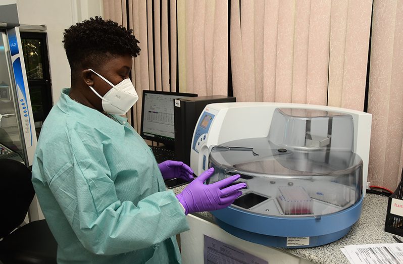 Genetic materials that allow microbiologists to determine whether a patient sample contains markers for the COVID-19 virus is being extracted from samples collected from individuals at the Eureka Medical Laboratory (Adrian Narine photo)