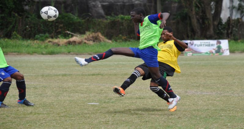Chronicle Sport Delano Williams was on hand to capture this player from Dolphin Secondary (green bib) evading a tackle from an opposing player of North Ruimveldt Multilateral Secondary, when the two sides met in a quarter-final encounter.