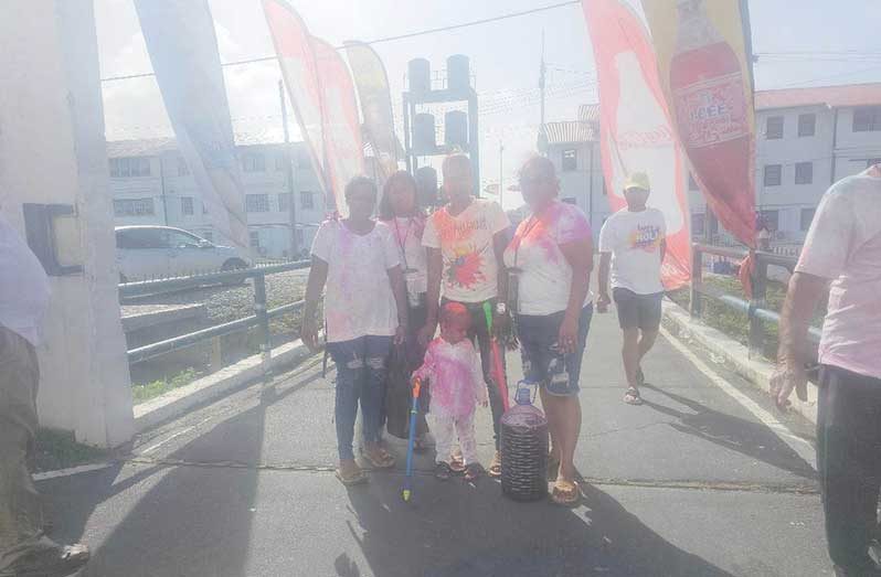 A family on their way to celebrate Holi at Everest Cricket Club Ground on Tuesday