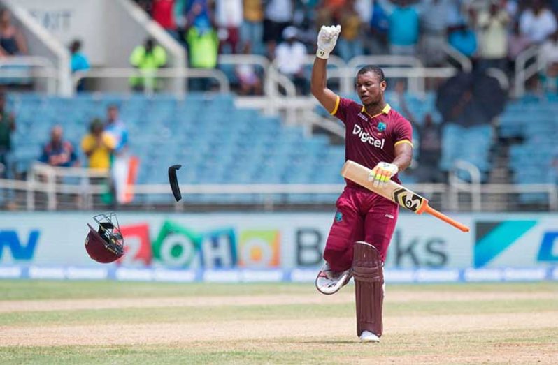 Evin Lewis chucks his helmet to the floor to celebrate his second T20I hundred against India at Sabina Park.