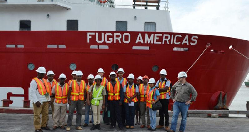 Staff of the Environmental Protection Agency (EPA) and the Guyana Geology and Mines Commission (GGMC) pose with ExxonMobil staff in front of the survey vessel