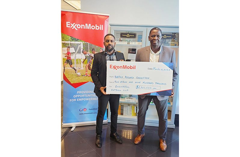 ExxonMobil’s Community Relations Adviser Public and Government Affairs Ryan Hoppie (left) hands over the cheque to Bartica Easter Regatta Committee Chairman, Kenneth Williams