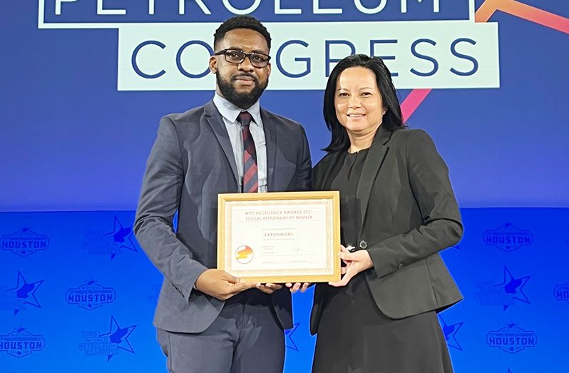 ExxonMobil’s Community Relations Manager, Suzie De Abreu, and the company’s Community Relations Adviser, Ryan Hoppie, share a light moment after receiving the World Petroleum Council Excellence Award (WPCEA) for Social Responsibility (ExxonMobil photo)