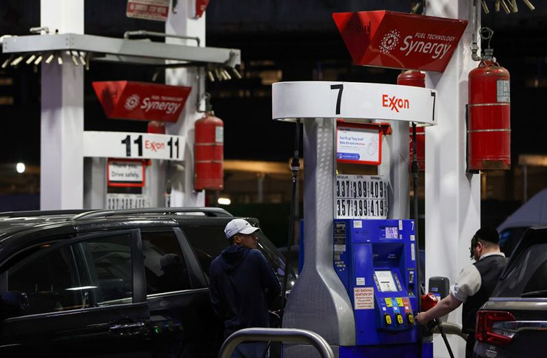 People pump gas at an Exxon gas station in Brooklyn, New York City (REUTERS/Andrew Kelly)