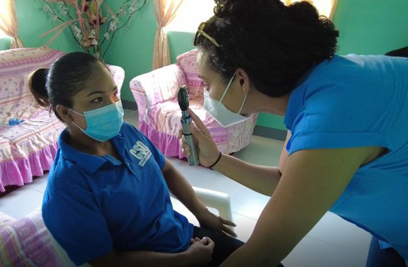 A doctor conducts an eye examination on a patient