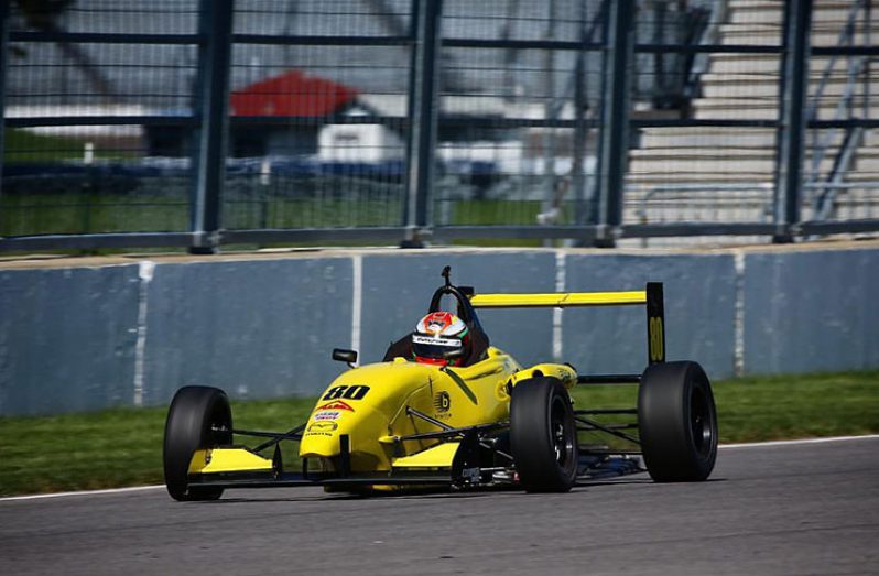 Calvin Ming sits in the F2000 car while his Mechanics do a brief check during the testing day at the Indianapolis Raceway