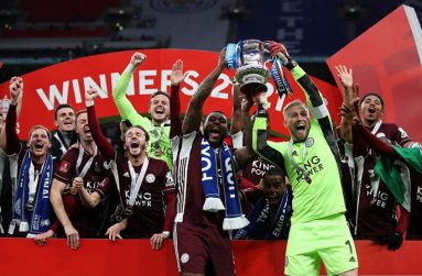 Leicester goalkeeper-captain Kasper Schmeichel (R) and club captain Wes Morgan lift the FA Cup after beating Chelsea at Wembley.