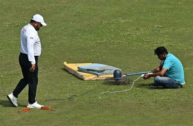 A member of the ground staff uses a fan to dry a patch of wet outfield  •  (AFP/Getty Images)