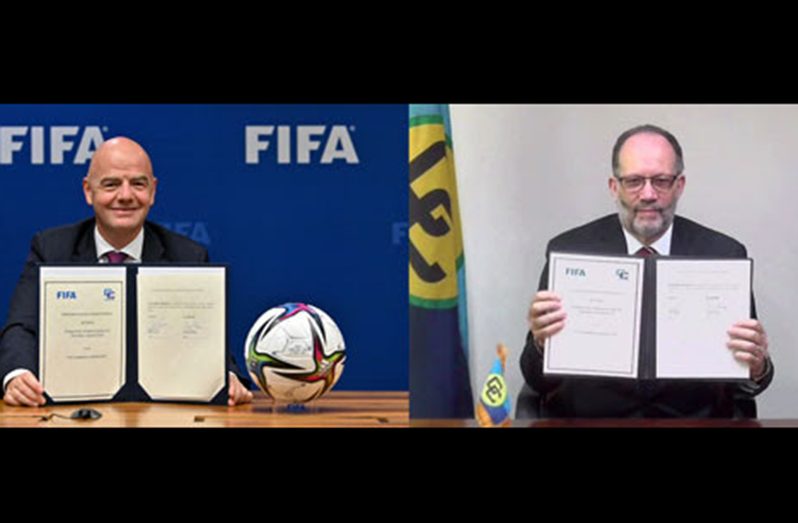 FIFA's president, Gianni Infantino (L) and CARICOM Secretary General, Ambassador Irwin LaRocque, following the signing of their MoU.