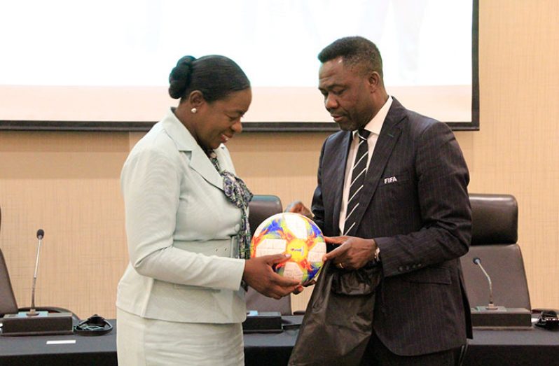 The official ball for the FIFA 2019 Women’s World Cup is being presented to Minister Henry by FIFA Member Association and Development Director, Veron Mosgengo-Omba. (Ministry of Education photo)