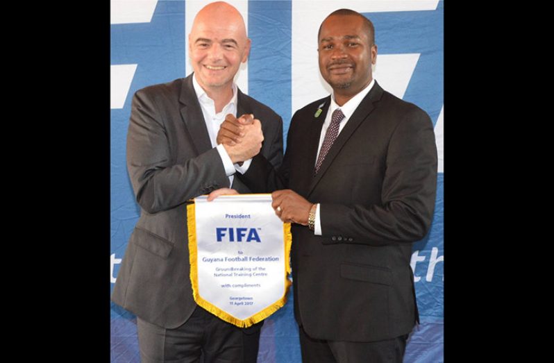 FIFA president Gianni Infantino (L) and GFF president Wayne Forde during his visit to Guyana in 2017.