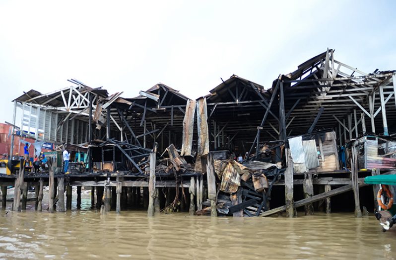 An alleged arson to the Stabroek Market Wharf left several stalls flattened at the Stabroek Market Wharf on Monday night (Delano Williams)