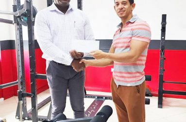Jamie Mc Donald, owner of Fitness Express hands over sponsorship to President of the Guyana Amateur Powerlifting Federation (GAPLF), Franklyn Wilson