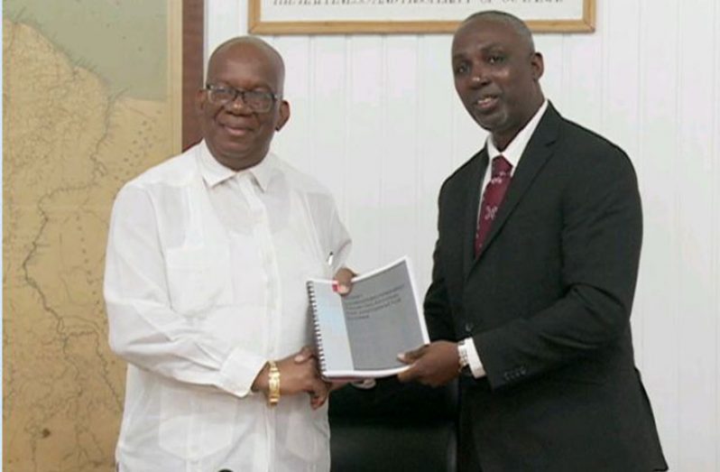 Minister of Finance, Winston Jordan, receiving the Money Laundering and Terrorist Financing Risk Assessment Report and Risk Based Action Plan from the Director of the Financial Intelligence Unit (FIU), Matthew Langevine