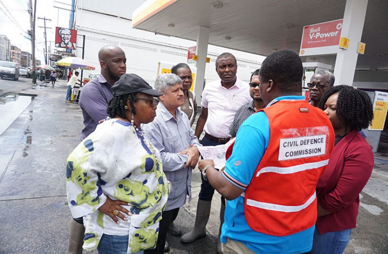 Assessing the flood situation in Albouystown are (from left), Minister within the Ministry of Public Infrastructure, Jaipaul Sharma; Mayor of Georgetown, Ubraj Narine; Councillor of Constituency 10, Heston Bostwick; and M&CC Councillor, Denroy Tudor (Carl Croker photo)