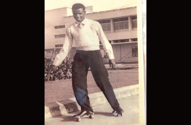 A youthful Francis Quamina Farrier skating on the Water Street pavement.  William Fogarty's store is in the background. The fence west of the garden was not erected at that time