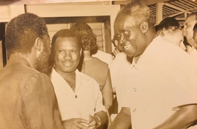 Farrier at left, has the undivided attention of Guyana's Minister of Finance,the Hon. Frank Hope, and President Kenneth Kaunda of Zambia during the latter's state Visit to Guyana