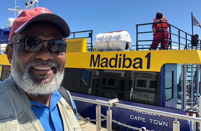 New York-based Guyanese journalist Hugh Hamilton on the ferry to Robben Island last February, just before the COVID-19 struck.