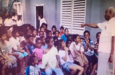 Farrier at right, in a performance of Poetry and Storytelling for youths at the Joshua House in Georgetown.