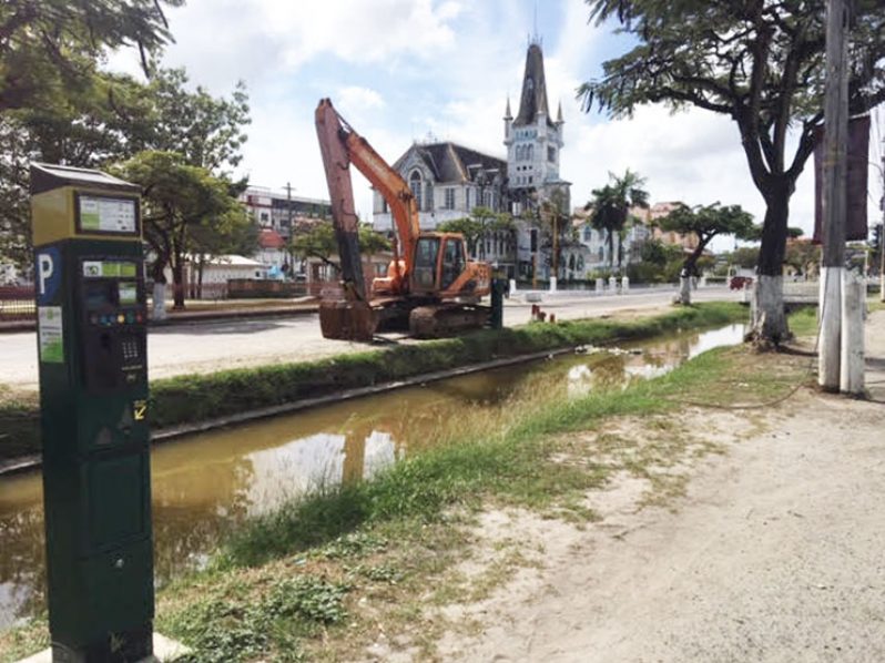 From left, one of the controversial Parking Meters, the Avenue of the Republic canal, a piece of heavy-duty equipment and in the background, the deteriorating City Hall (Photo by F.Q. Farrier - 2018)