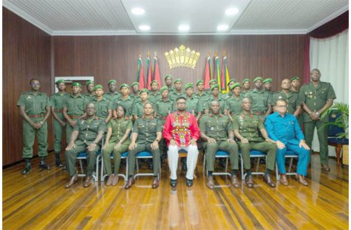 President Dr. Mohamed Irfaan Ali (centre) is flanked by Chief of Defence Staff, Brigadier Omar Khan; Colonel Sheldon Howell; and Director of the National
Intelligence and Security Agency and National Security Advisor, Captain Gerry Gouveia (Ret’d), along with the 22 newly commissioned Second Lieutenants of
the Guyana Defence Force (GDF) following the presentation of instruments of commission and state warrants at State House on Friday (DPI photo)