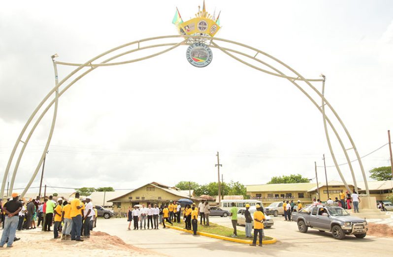 Lindeners converge under the Centennial Arch, which was constructed by Bosai Minerals Group (Guyana) Limited in celebration of the 100 years of bauxite mining in Linden. (Adrian Narine photo)