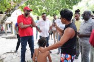 President Dr. Irfaan Ali engaging with residents during Saturday’s outreach at Kuru Kuru, along the Soesdyke-Linden Highway, where he announced major interventions in
housing, roads, electricity, water, education, and youth development as part of the government’s push to accelerate the community’s development (GPL photo)