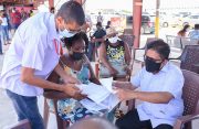 Senior Minister within the Office of the President with responsibility for Finance, Dr. Ashni Singh addressing a citizen’s concern during an NIS outreach at the Giftland Mall on Saturday (Delano Williams photo)