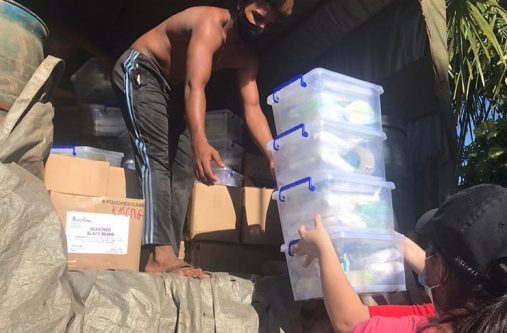 Team members help to pack the health centre COVID-19 kits in the truck provided