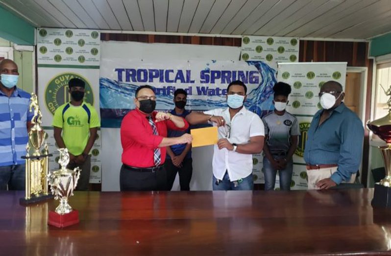 President of the GCB Bissoondyal Singh (right) receives the sponsorship of Falcons from Aravinda Gainda of Tropical Spring