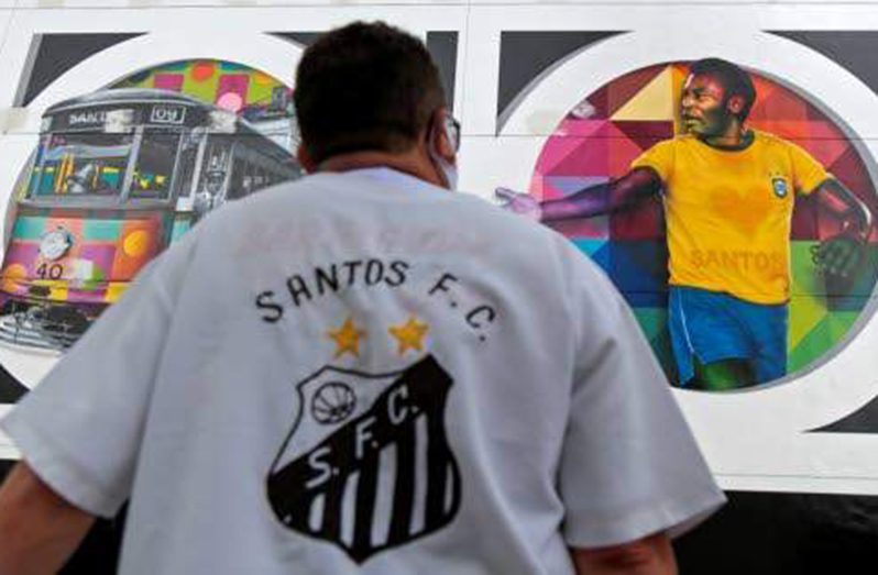 A fan of Santos football club looks at a mural by Brazilian artist Kobra depicting retired Brazilian football star Edson Arantes do Nascimento, known as Pele, in Santos, Sao Paulo state, Brazil, on Wednesday. The work, called 'Coracao Santista' (Santos' Heart), was finished days ahead of the 80th birthday of the football legend yesterday. (Photos: AFP)