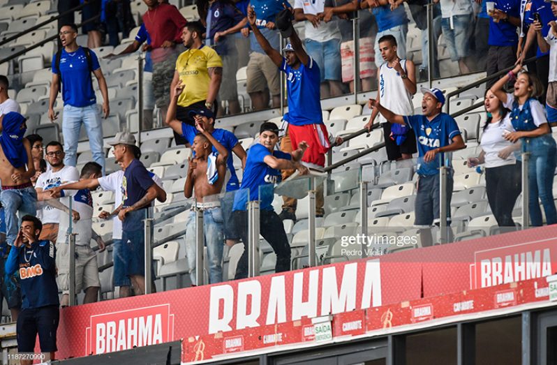 Fans of Cruzeiro react after losing a match against Palmeiras as part of Brasileirao Series A 2019 at Mineirao Stadium on December 8, 2019 in Belo Horizonte, Brazil. Cruzeiro have been relegated from the Brasileiro Serie A for the first time in the club's history. (Photo by Pedro Vilela/Getty Images)