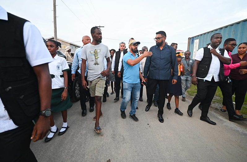 President, Dr Mohamed Irfaan Ali listens to residents in Farm during the walkabout exercise