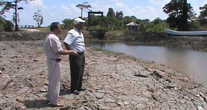 Minister Alli Baksh and Region Two Vice Chairman Vishnu Samaroo inspecting a canal that was desilted under the NDIA’s $81M drainage project on the Essequibo Coast
