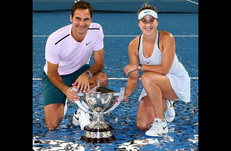 Roger Federer and Belinda Bencic of Switzerland pose with the Hopman Cup trophy. Photograph: Paul Kane/Getty Images