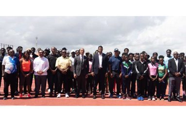 Felix Sanchez along with Minister Charles Ramson Jr. and other officials and athletes prior to the start of the clinic